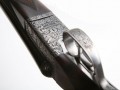 Base of scrollback Boxlock, full scroll engraving and gunmakers name